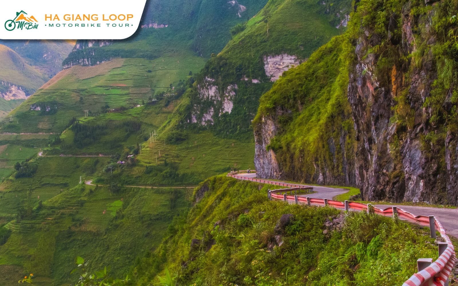 S-shaped Tham Ma Pass road in Ha Giang with cliffs and buckwheat fields.