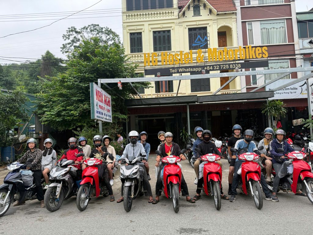 Mr. Biu riders on motorbikes outside the hostel in Ha Giang city