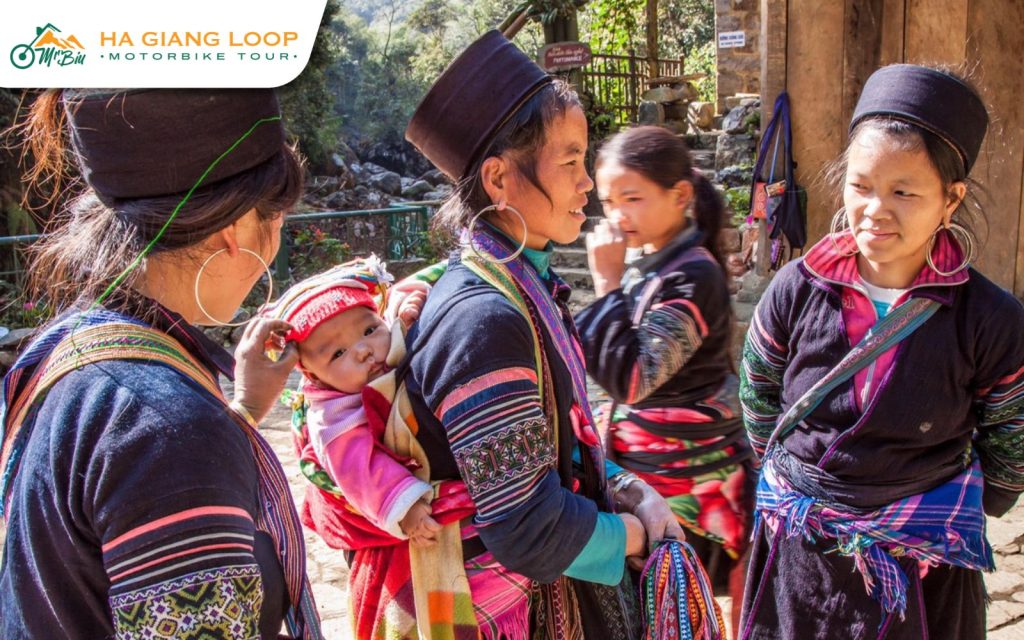 H’mong villagers in traditional dress welcoming visitors along the Ma Pi Leng Pass Vietnam