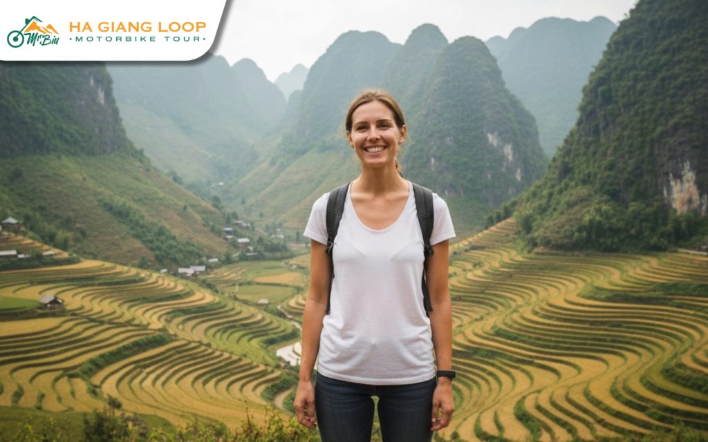 A solo female traveler takes in the breathtaking views from Ma Pi Leng Pass, one of the most iconic stops on the Ha Giang Loop. Female traveler admiring Ma Pi Leng Pass scenery