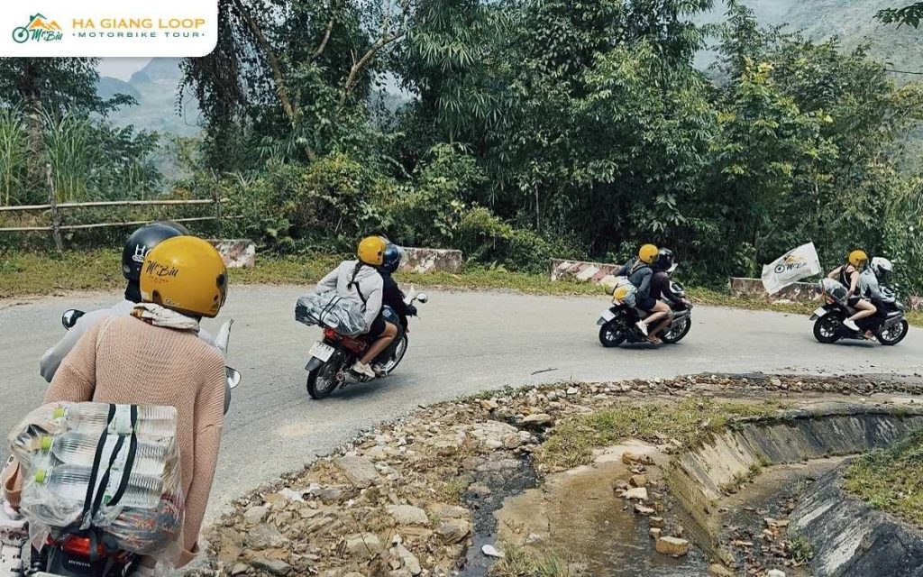 Guide and riders taking a hairpin bend on a mountain road