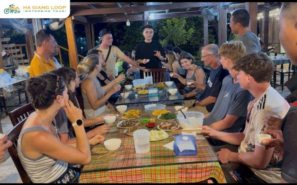 Riders sharing a family dinner at a homestay