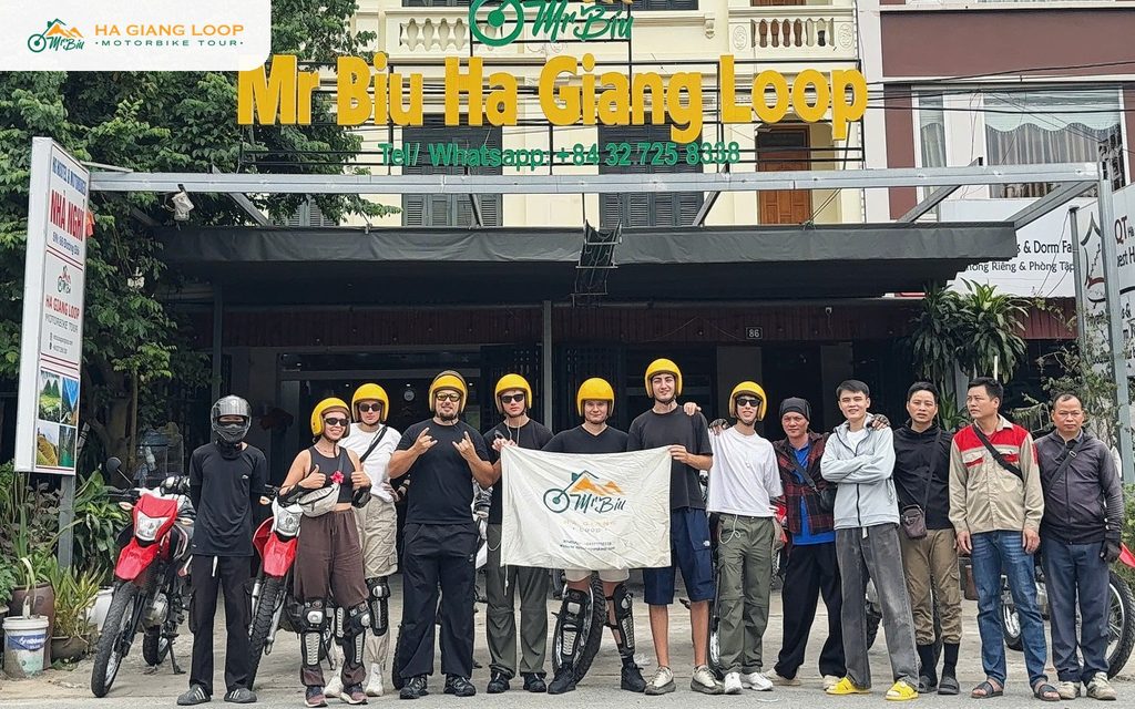 Mr. Biu tour group with guides outside the office before a Ha Giang Loop trip