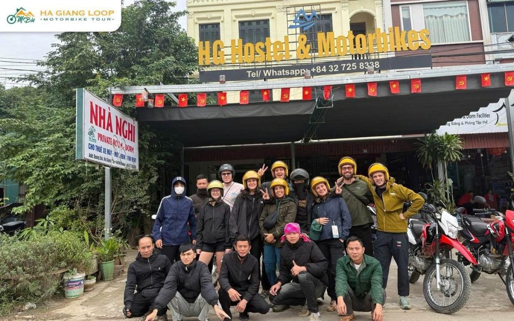 Mr. Biu group in helmets outside the hostel in Ha Giang city