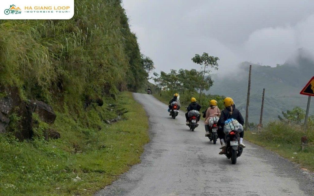 Mr. Biu riders on a quiet mountain road in Ha Giang