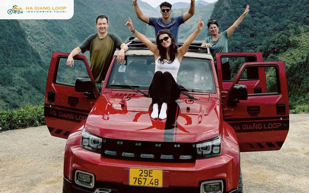 Travellers doing the Ha Giang loop by car in an open-top red jeep