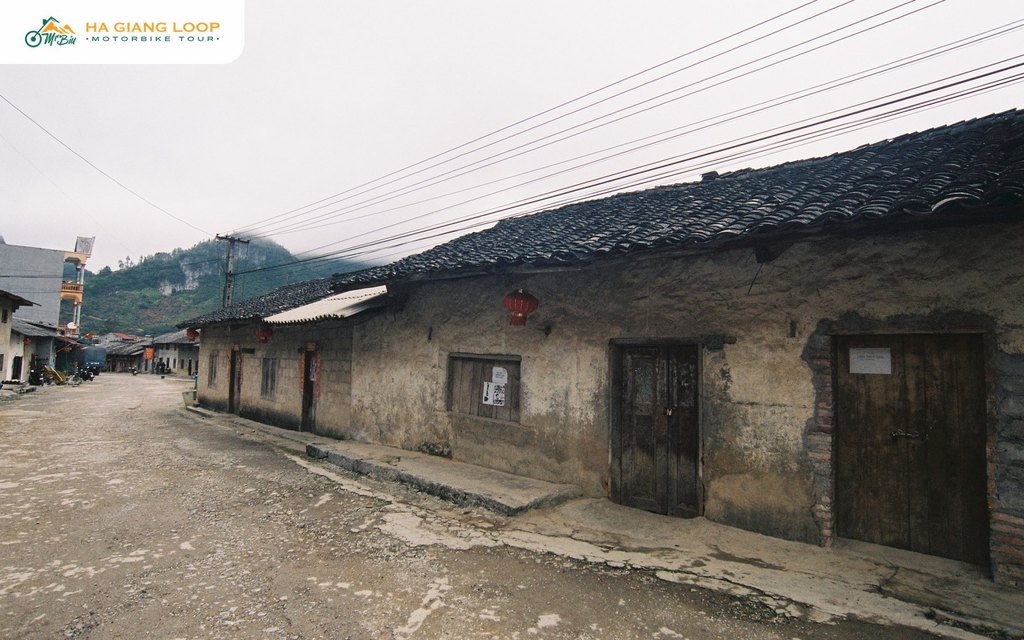 Old street in Pho Bang with a red lantern hanging on a clay house wall