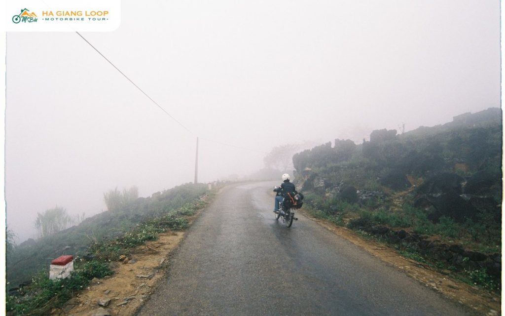 Lone rider on a foggy road where a bike breakdown on Ha Giang Loop happens