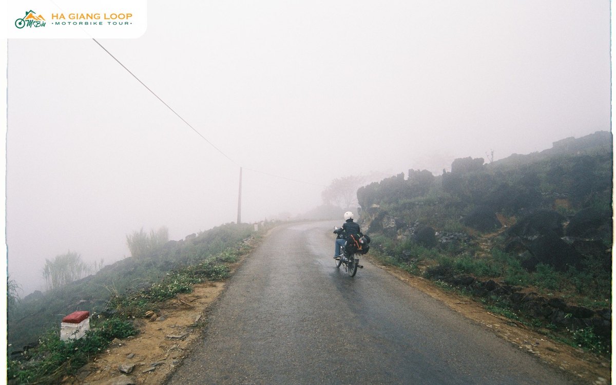 Lone rider on a foggy road where a bike breakdown on Ha Giang Loop happens