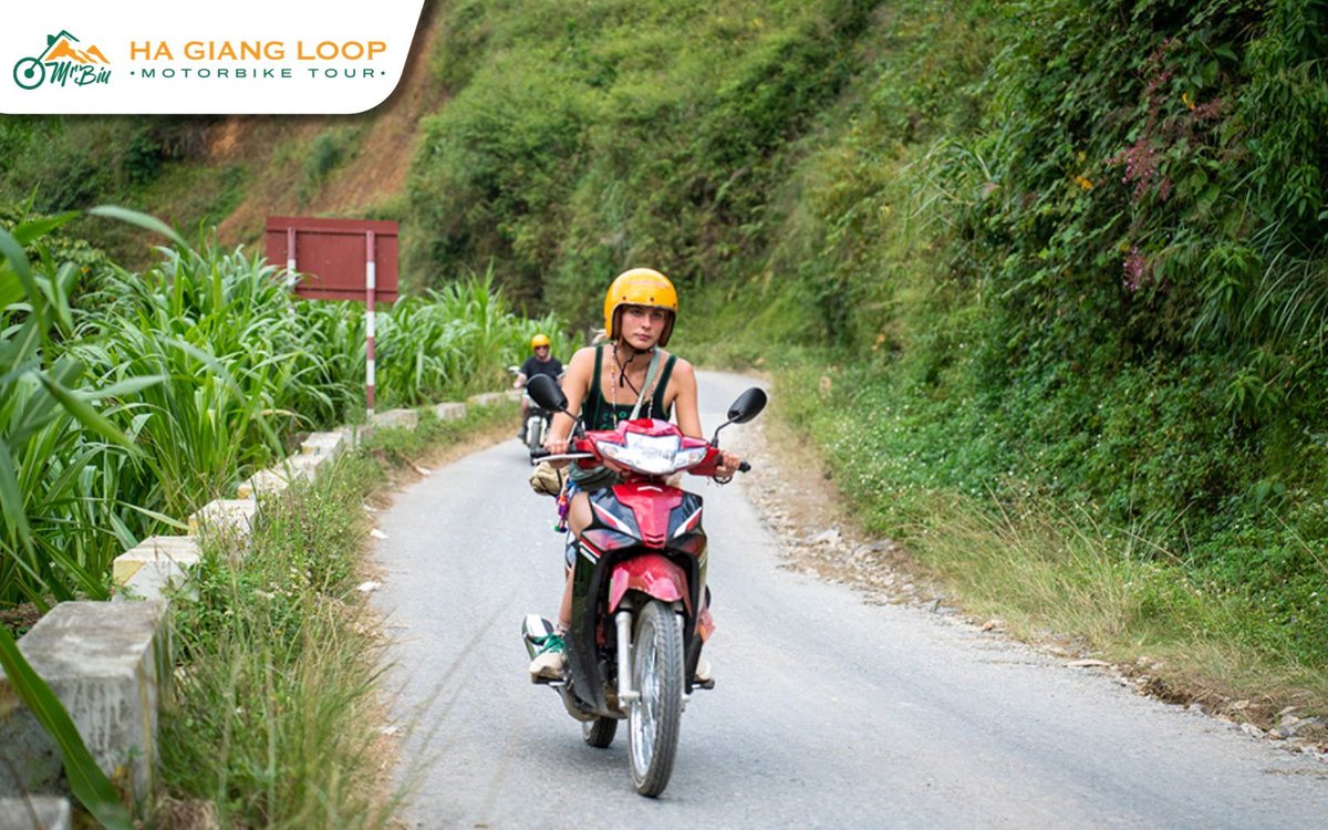 Rider on a semi-automatic motorbike on a quiet road in Ha Giang